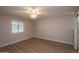 Spacious bedroom with light walls, ceiling fan, and window with blinds at 4502 E Carol Ave # 1, Mesa, AZ 85206