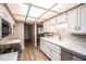 Bright kitchen features stainless dishwasher and sink, ample white cabinetry, and light countertops at 4502 E Carol Ave # 1, Mesa, AZ 85206