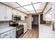 Bright kitchen features stainless appliances, ample white cabinetry, and light countertops at 4502 E Carol Ave # 1, Mesa, AZ 85206