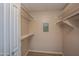 Open walk-in closet features built-in shelving at 4502 E Carol Ave # 1, Mesa, AZ 85206
