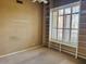 An empty bedroom features light brown walls, carpet and bright window at 4843 E Estevan Rd, Phoenix, AZ 85054