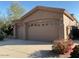 Exterior of the home featuring a two-car garage with a well-maintained driveway and landscaping at 4843 E Estevan Rd, Phoenix, AZ 85054