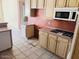 This kitchen is equipped with appliances and cabinets at 4843 E Estevan Rd, Phoenix, AZ 85054