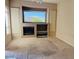 An empty living room features beige carpet, light brown walls, and a decorative fireplace at 4843 E Estevan Rd, Phoenix, AZ 85054