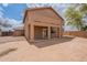 An empty backyard featuring a covered patio and a view of the home's exterior at 504 E Racine Pl, Casa Grande, AZ 85122