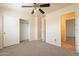 Bedroom with neutral carpet, ceiling fan, and closet with sliding doors at 504 E Racine Pl, Casa Grande, AZ 85122