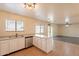 Open kitchen featuring stainless steel dishwasher and breakfast bar flowing into living area at 504 E Racine Pl, Casa Grande, AZ 85122
