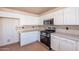 Well-lit kitchen with stainless steel appliances, white cabinetry, and tiled backsplash at 504 E Racine Pl, Casa Grande, AZ 85122