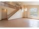 Open-concept living area features high ceilings, tile floors, and a grand staircase at 504 E Racine Pl, Casa Grande, AZ 85122
