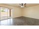 Spacious living room with vinyl flooring and sliding glass doors to the outdoor patio at 504 E Racine Pl, Casa Grande, AZ 85122