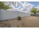 Spacious backyard featuring gravel, lush trees, and privacy wall at 507 W Magdalena Ln, Phoenix, AZ 85041