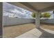 Backyard featuring a covered patio with a privacy wall and desert landscaping at 507 W Magdalena Ln, Phoenix, AZ 85041