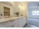 Bathroom featuring a dual sink vanity, gold fixtures, and large mirrors at 507 W Magdalena Ln, Phoenix, AZ 85041