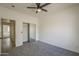Neutral-colored bedroom featuring gray carpet, a ceiling fan and a mirrored closet at 507 W Magdalena Ln, Phoenix, AZ 85041