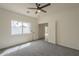Bedroom featuring natural light, gray carpet, and back patio access at 507 W Magdalena Ln, Phoenix, AZ 85041