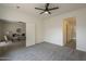 This bedroom features carpeted floors, a ceiling fan, and an ensuite bathroom at 507 W Magdalena Ln, Phoenix, AZ 85041