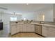 Bright kitchen featuring stainless steel appliances, white cabinets, and an undermount sink at 507 W Magdalena Ln, Phoenix, AZ 85041