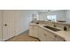 A view of the kitchen, featuring shaker cabinets, tile backsplash and stainless steel sink at 507 W Magdalena Ln, Phoenix, AZ 85041