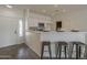 Modern kitchen features white cabinetry, stainless steel appliances, and a breakfast bar with seating at 507 W Magdalena Ln, Phoenix, AZ 85041
