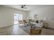 Sunlit living room with neutral decor, tile flooring, and sliding glass doors to the backyard at 507 W Magdalena Ln, Phoenix, AZ 85041