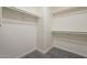 Spacious walk-in closet with ample shelving and gray carpeting, perfect for organization at 507 W Magdalena Ln, Phoenix, AZ 85041