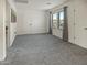 A spacious bedroom with neutral carpet, two windows with curtains, and white doors at 5110 E Peak View Rd, Cave Creek, AZ 85331