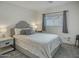 A cozy bedroom with carpet floors, a comfortable gray bed, and a window with gray curtains at 5110 E Peak View Rd, Cave Creek, AZ 85331