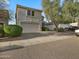 Two-story home featuring a two-car garage and desert landscaping at 5110 E Peak View Rd, Cave Creek, AZ 85331
