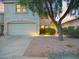 Charming home with a two-car garage, desert landscaping, and inviting outdoor lighting at 5110 E Peak View Rd, Cave Creek, AZ 85331