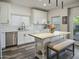 Bright kitchen features white cabinets, stainless steel appliances, subway tile backsplash, and a butcher block island with bench seating at 5110 E Peak View Rd, Cave Creek, AZ 85331