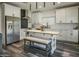 Bright kitchen features white cabinets, stainless steel appliances, subway tile backsplash, and a butcher block island with bench seating at 5110 E Peak View Rd, Cave Creek, AZ 85331