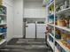 A laundry room area with washer, dryer, white cabinets, and shelving at 5110 E Peak View Rd, Cave Creek, AZ 85331