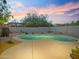Backyard view of the pool with desert landscaping under a colorful sunset sky at 5110 E Peak View Rd, Cave Creek, AZ 85331
