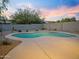 Backyard view of the pool with desert landscaping under a colorful sunset sky at 5110 E Peak View Rd, Cave Creek, AZ 85331