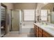 Bright bathroom featuring a tub, a separate shower, and double sink vanity at 5432 N Ormondo Way, Litchfield Park, AZ 85340