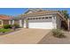 Single-story home with a two-car garage and neutral desert landscaping at 5432 N Ormondo Way, Litchfield Park, AZ 85340