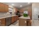 Well-lit kitchen featuring an island, stainless steel appliances, and wood cabinets at 5432 N Ormondo Way, Litchfield Park, AZ 85340