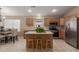 Spacious kitchen features an island, stainless appliances, and tile flooring at 5432 N Ormondo Way, Litchfield Park, AZ 85340