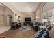 Bright living room featuring a sleek TV, cozy couches, and large windows at 5432 N Ormondo Way, Litchfield Park, AZ 85340