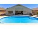 A refreshing blue pool is nestled against the back of the home, leading to an indoor-outdoor living space at 5432 N Ormondo Way, Litchfield Park, AZ 85340