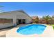This backyard features a beautiful pool and a putting green, perfect for leisurely afternoons and fun gatherings at 5432 N Ormondo Way, Litchfield Park, AZ 85340