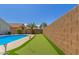 An expansive backyard features a pool and dedicated putting green, perfect for leisurely outdoor entertainment at 5432 N Ormondo Way, Litchfield Park, AZ 85340