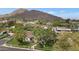 Aerial view of the property with views of nearby mountain range and surrounding community at 6102 E Calle Del Norte --, Scottsdale, AZ 85251