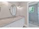 Bright bathroom featuring marble countertops, white cabinetry, and a glass-enclosed shower with herringbone tile at 6102 E Calle Del Norte --, Scottsdale, AZ 85251