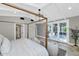 Bright bedroom with white French doors, four-poster bed, and comfortable seating area at 6102 E Calle Del Norte --, Scottsdale, AZ 85251