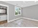 Bright bedroom features light hardwood floors, large window, and gray walls at 6102 E Calle Del Norte --, Scottsdale, AZ 85251