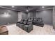 A home theater room with tiered seating, ceiling fan, and patterned curtains at 6102 E Calle Del Norte --, Scottsdale, AZ 85251