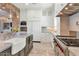 Well-equipped kitchen with stainless steel appliances, custom cabinetry, and a view into the living area at 6102 E Calle Del Norte --, Scottsdale, AZ 85251