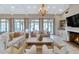 Elegant living room with wood floors, large windows, lots of seating and fireplace at 6102 E Calle Del Norte --, Scottsdale, AZ 85251