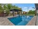 Beautiful backyard with a pool, cozy fire pit area, and meticulously maintained landscaping at 6102 E Calle Del Norte --, Scottsdale, AZ 85251